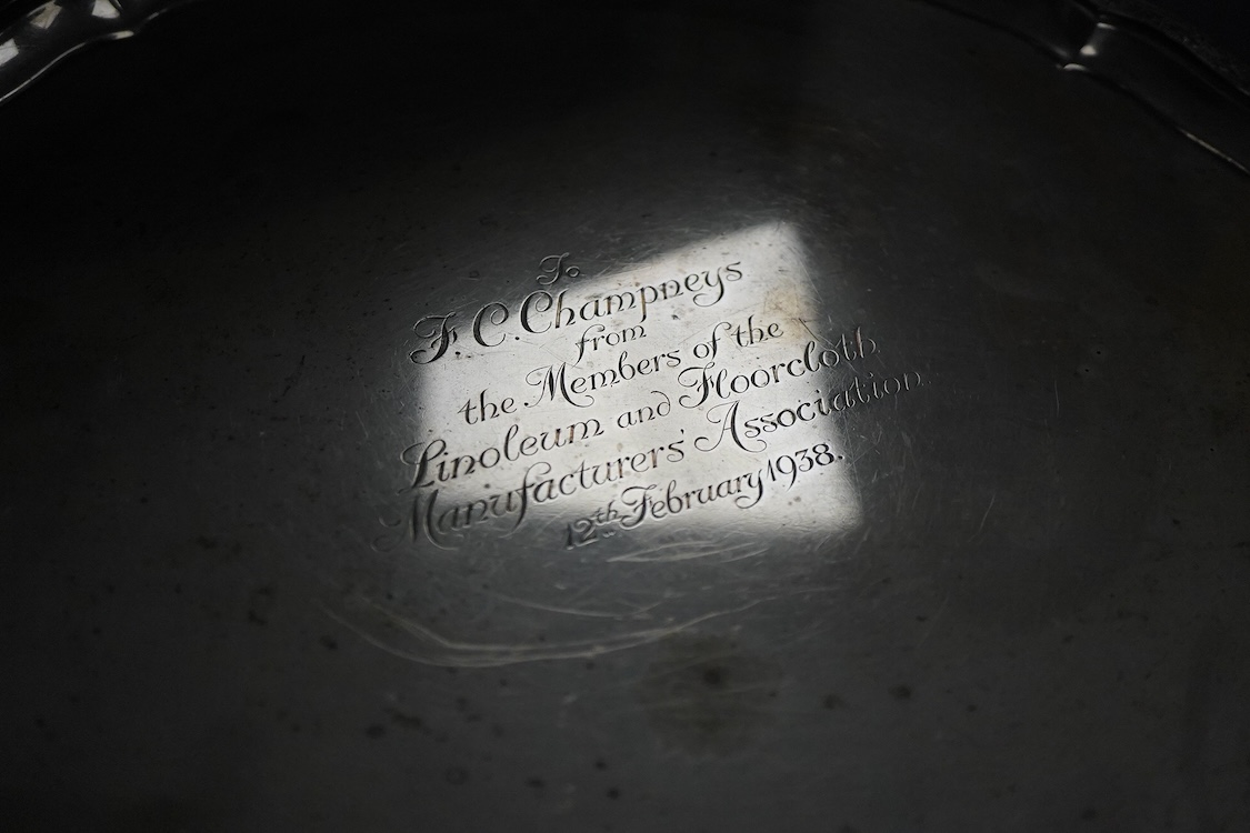 A George VI silver salver, of shaped circular form, on four claw and ball feet, with presentation inscription, Reid & Sons, London, 1936, 35.7cm, 40.5oz.
